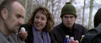 Movie still from “Flickering Lights” (2000), directed by Anders Thomas Jensen – A woman sitting next to a man in a green hat; Close Up shot, Over the shoulder angle