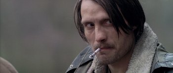 Movie still from “Flickering Lights” (2000), directed by Anders Thomas Jensen – A person smoking a cigarette; Close Up shot, Over the shoulder angle