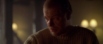 Movie still from “Flickering Lights” (2000), directed by Anders Thomas Jensen – A man in a sweater looking down at his face; Close Up shot, Over the shoulder angle