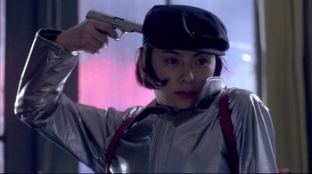 A woman holding a gun up to her head