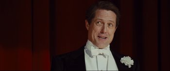 Movie still from “Florence Foster Jenkins” (2016), directed by Stephen Frears – A man wearing a tuxedo and a bow tie; Close Up shot, Low angle