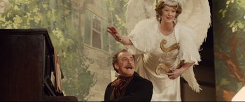 Movie still from “Florence Foster Jenkins” (2016), directed by Stephen Frears – A man and a woman dressed as an angel; Medium shot, Low angle