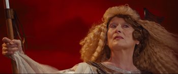 Movie still from “Florence Foster Jenkins” (2016), directed by Stephen Frears – An older woman with blonde curly hair is looking up; Close Up shot, Low angle