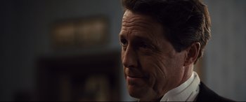 Movie still from “Florence Foster Jenkins” (2016), directed by Stephen Frears – A man's face in the dark; Close Up shot, Over the shoulder angle