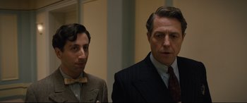 Movie still from “Florence Foster Jenkins” (2016), directed by Stephen Frears – Two men in suits and ties standing next to each other; Close Up shot, Low angle