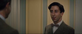 Movie still from “Florence Foster Jenkins” (2016), directed by Stephen Frears – A man wearing a suit and a bow tie; Close Up shot, Over the shoulder angle