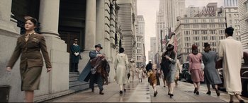 Movie still from “Florence Foster Jenkins” (2016), directed by Stephen Frears – A crowd of people walking down a sidewalk; Wide shot, High angle