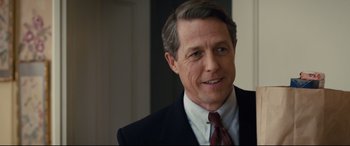 Movie still from “Florence Foster Jenkins” (2016), directed by Stephen Frears – A person wearing a suit and tie; Close Up shot, Over the shoulder angle