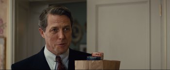Movie still from “Florence Foster Jenkins” (2016), directed by Stephen Frears – A person holding a paper bag; Close Up shot, Over the shoulder angle