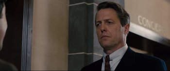 Movie still from “Florence Foster Jenkins” (2016), directed by Stephen Frears – A man in a suit and tie; Close Up shot, Low angle