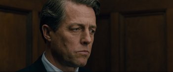 Movie still from “Florence Foster Jenkins” (2016), directed by Stephen Frears – A person wearing a suit and tie; Close Up shot, Over the shoulder angle