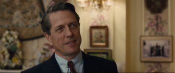 Movie still from “Florence Foster Jenkins” (2016), directed by Stephen Frears – A person wearing a suit and tie; Close Up shot, Over the shoulder angle