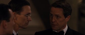 Movie still from “Florence Foster Jenkins” (2016), directed by Stephen Frears – Two men in suits talking to each other; Close Up shot, Over the shoulder angle