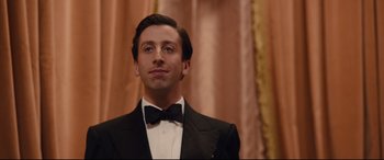Movie still from “Florence Foster Jenkins” (2016), directed by Stephen Frears – A person wearing a suit and bow tie; Close Up shot, Low angle