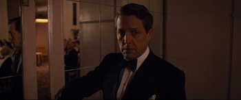 Movie still from “Florence Foster Jenkins” (2016), directed by Stephen Frears – A person wearing a suit and a bow tie; Close Up shot, Over the shoulder angle