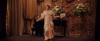 Movie still from “Florence Foster Jenkins” (2016), directed by Stephen Frears – A man and woman dressed up in fancy clothing; Wide shot, High angle