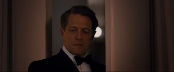 Movie still from “Florence Foster Jenkins” (2016), directed by Stephen Frears – A man in a tuxedo standing next to a door; Close Up shot, Over the shoulder angle