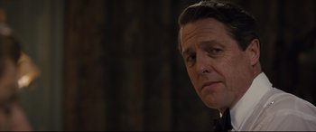 Movie still from “Florence Foster Jenkins” (2016), directed by Stephen Frears – A person wearing a suit and tie; Close Up shot, Over the shoulder angle