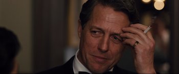 Movie still from “Florence Foster Jenkins” (2016), directed by Stephen Frears – A person wearing a suit and bow tie; Close Up shot, Over the shoulder angle