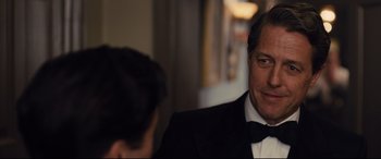 Movie still from “Florence Foster Jenkins” (2016), directed by Stephen Frears – A man in a tuxedo is looking at a woman in a black dress; Close Up shot, Over the shoulder angle