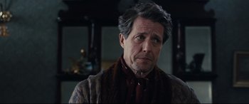 Movie still from “Florence Foster Jenkins” (2016), directed by Stephen Frears – A person wearing a suit and tie; Close Up shot, Over the shoulder angle