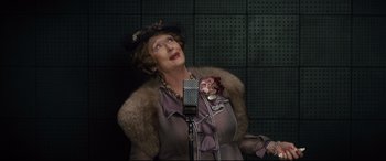 Movie still from “Florence Foster Jenkins” (2016), directed by Stephen Frears – An older woman wearing a hat and a fur coat; Close Up shot, Low angle