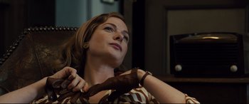Movie still from “Florence Foster Jenkins” (2016), directed by Stephen Frears – A woman is tying a tie around her neck; Close Up shot, Low angle