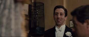 Movie still from “Florence Foster Jenkins” (2016), directed by Stephen Frears – A man in a tuxedo smiling for the camera; Close Up shot, Low angle