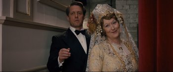 Movie still from “Florence Foster Jenkins” (2016), directed by Stephen Frears – A man and a woman dressed in formal wear; Close Up shot, Over the shoulder angle