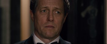 Movie still from “Florence Foster Jenkins” (2016), directed by Stephen Frears – A person wearing a suit and bow tie; Close Up shot, Low angle