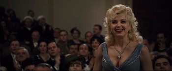 Movie still from “Florence Foster Jenkins” (2016), directed by Stephen Frears – A woman in a blue dress standing in front of an audience; Medium shot, Over the shoulder angle