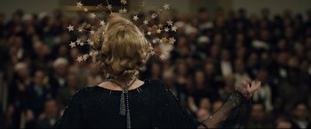 Movie still from “Florence Foster Jenkins” (2016), directed by Stephen Frears – A woman in a black dress with stars in her hair; Close Up shot, Overhead angle