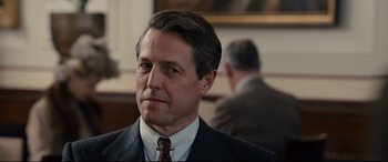Movie still from “Florence Foster Jenkins” (2016), directed by Stephen Frears – A person wearing a suit and tie; Close Up shot, Over the shoulder angle
