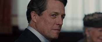Movie still from “Florence Foster Jenkins” (2016), directed by Stephen Frears – A person wearing a suit and tie; Close Up shot, Over the shoulder angle