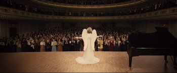 Movie still from “Florence Foster Jenkins” (2016), directed by Stephen Frears – A woman dressed as an angel in front of an audience; Wide shot, High angle