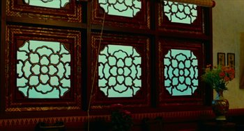 Movie still from “Flowers of Shanghai” (1998), directed by Hsiao-Hsien Hou – A room with a lot of stained glass in it; Wide shot, Low angle
