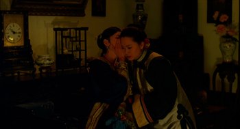 Movie still from “Flowers of Shanghai” (1998), directed by Hsiao-Hsien Hou – Two women in traditional clothing are talking to each other; Medium shot, Over the shoulder angle