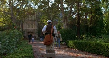 Movie still from “Flubber” (1997), directed by Les Mayfield – A man with a backpack walking down a path; Wide shot, High angle