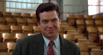 Movie still from “Flubber” (1997), directed by Les Mayfield – A person wearing a suit and a tie; Close Up shot, Over the shoulder angle