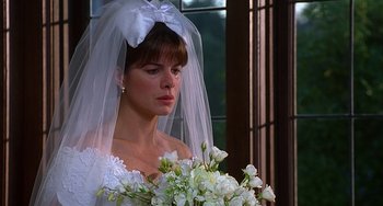Movie still from “Flubber” (1997), directed by Les Mayfield – A woman in a wedding dress holding a bouquet of flowers; Close Up shot, Over the shoulder angle