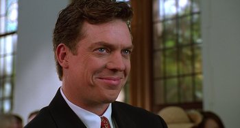 Movie still from “Flubber” (1997), directed by Les Mayfield – A person wearing a suit and tie; Close Up shot, Over the shoulder angle
