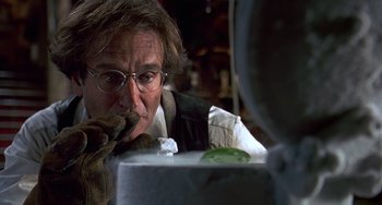 Movie still from “Flubber” (1997), directed by Les Mayfield – A man with glasses looking at something in a mirror; Close Up shot, Over the shoulder angle