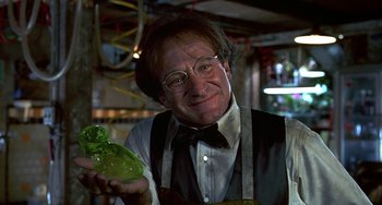Movie still from “Flubber” (1997), directed by Les Mayfield – An older man holding a green object in his hand; Close Up shot, Over the shoulder angle