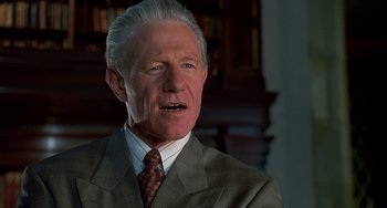 Movie still from “Flubber” (1997), directed by Les Mayfield – An older man wearing a suit and tie; Close Up shot, Low angle