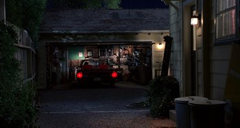 Movie still from “Flubber” (1997), directed by Les Mayfield – A car is parked in a garage at night; Extreme Wide shot, High angle