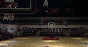 Movie still from “Flubber” (1997), directed by Les Mayfield – A man jumping in the air on a basketball court; Wide shot, Low angle