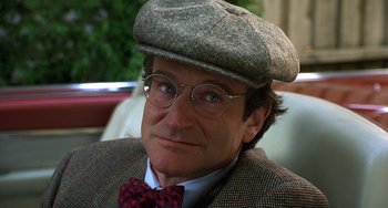 Movie still from “Flubber” (1997), directed by Les Mayfield – A person wearing glasses and a hat; Close Up shot, Over the shoulder angle