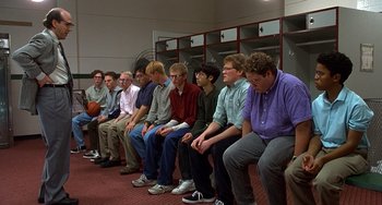 Movie still from “Flubber” (1997), directed by Les Mayfield – A group of men sitting in a row in a room; Wide shot, High angle
