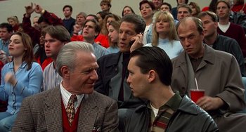 Movie still from “Flubber” (1997), directed by Les Mayfield – A group of people sitting in a room; Medium shot, Over the shoulder angle