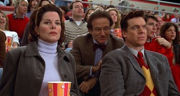 Movie still from “Flubber” (1997), directed by Les Mayfield – A group of people sitting next to each other in a stadium; Medium shot, Low angle
